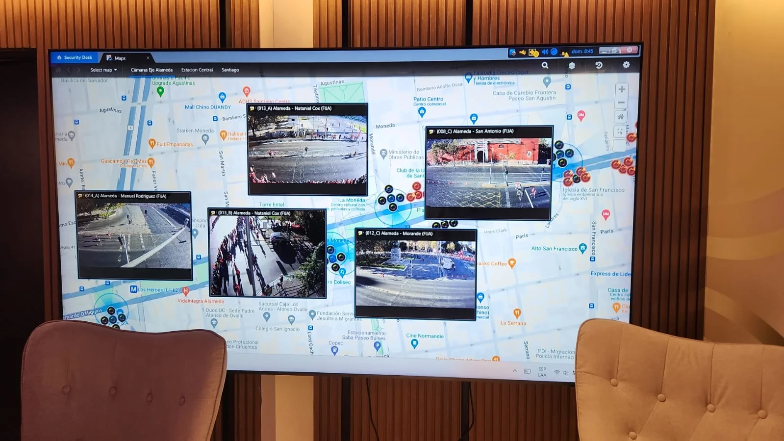 Large wall-mounted CEGIR display with a city map and CCTV pins plus live thumbnail camera feeds.